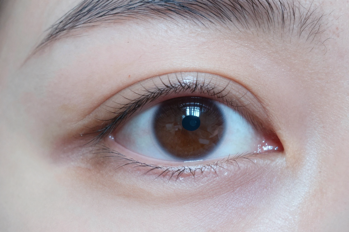Macro close-up of an eye and skin showing pores and micro-detail a real camera captures