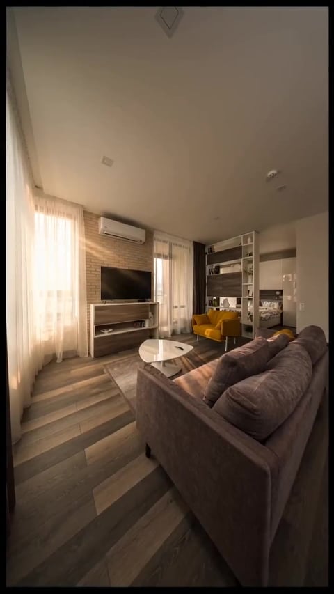 A frame from a golden-hour showcase real estate reel generated by the Imagera Real Estate Reel Maker — warm sunset light on the interior, built from the same listing photo