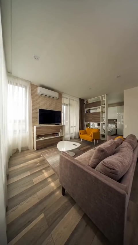 A frame from a cozy interior pan real estate reel generated by the Imagera Real Estate Reel Maker — a slow warm pan across living space, built from the same listing photo