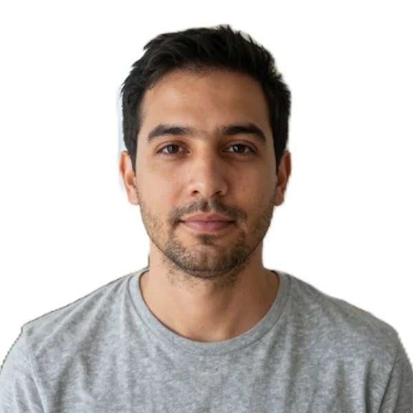 The same man cropped to a document photo: centred, evenly lit, neutral expression, on a plain white background